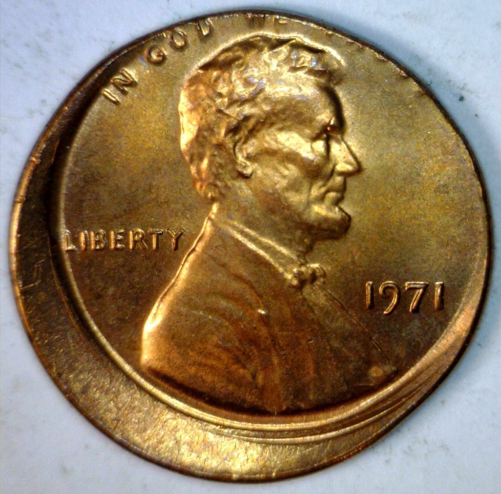 1971 penny off-center strike error showing Lincoln portrait shifted with blank crescent area and visible date